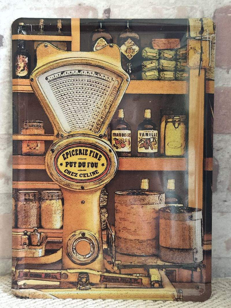 Vintage Puy du Fou French metal advertising sign featuring a delicatessen scale design, 21cm by 15cm.