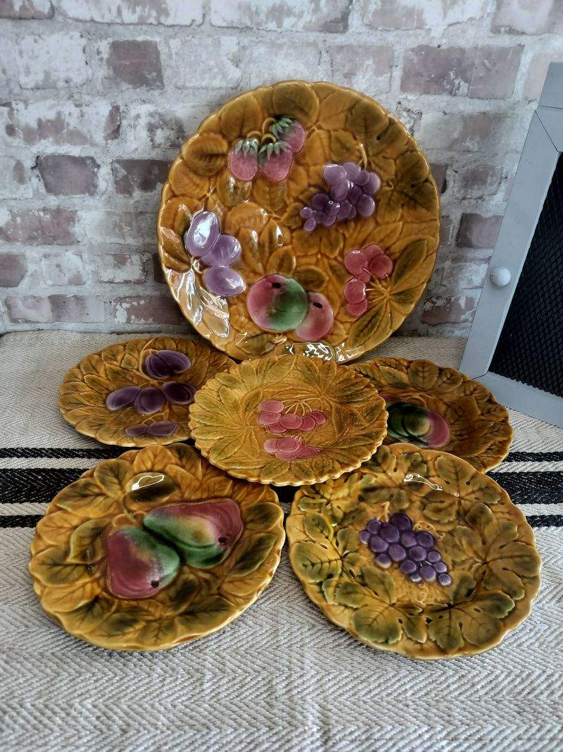 Set of 6 vintage Sarreguemines Majolica plates with raised fruit motifs on mustard yellow backgrounds