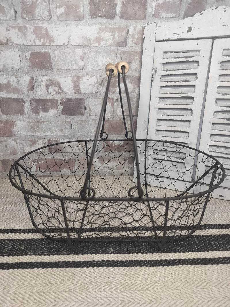 Vintage French picking basket with wire mesh and wooden handles, rustic farmhouse style.