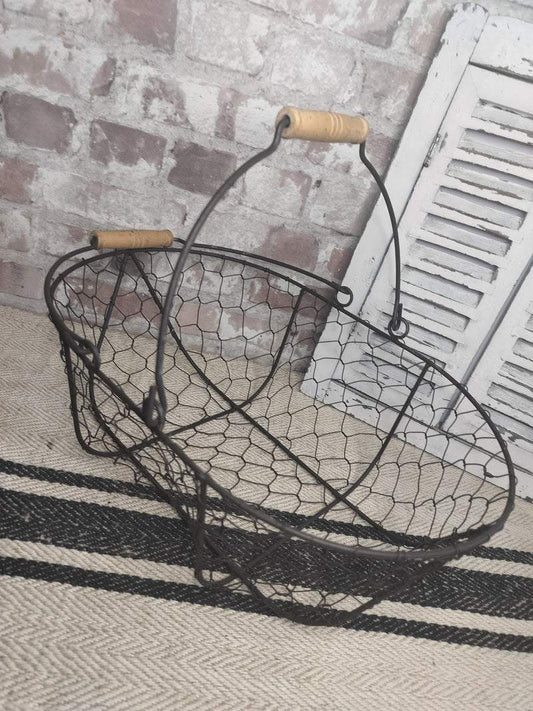 Vintage French picking basket with wire mesh and wooden handles, rustic farmhouse style.