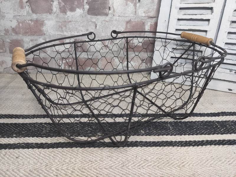 Vintage French picking basket with wire mesh and wooden handles, rustic farmhouse style.