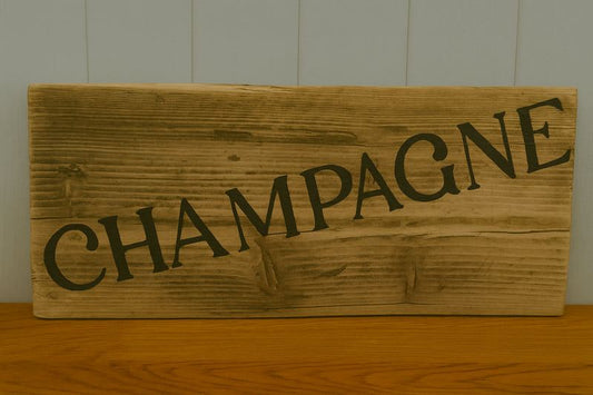 Upcycled handmade wooden champagne sign with rustic natural wood and black lettering for indoor and outdoor decor