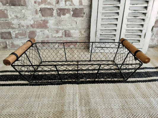 Vintage French oblong metal basket with black wire mesh and wooden handles for rustic farmhouse storage