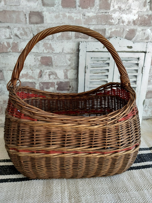 French vintage wicker basket with red detailing and curved handle for rustic home decor and storage