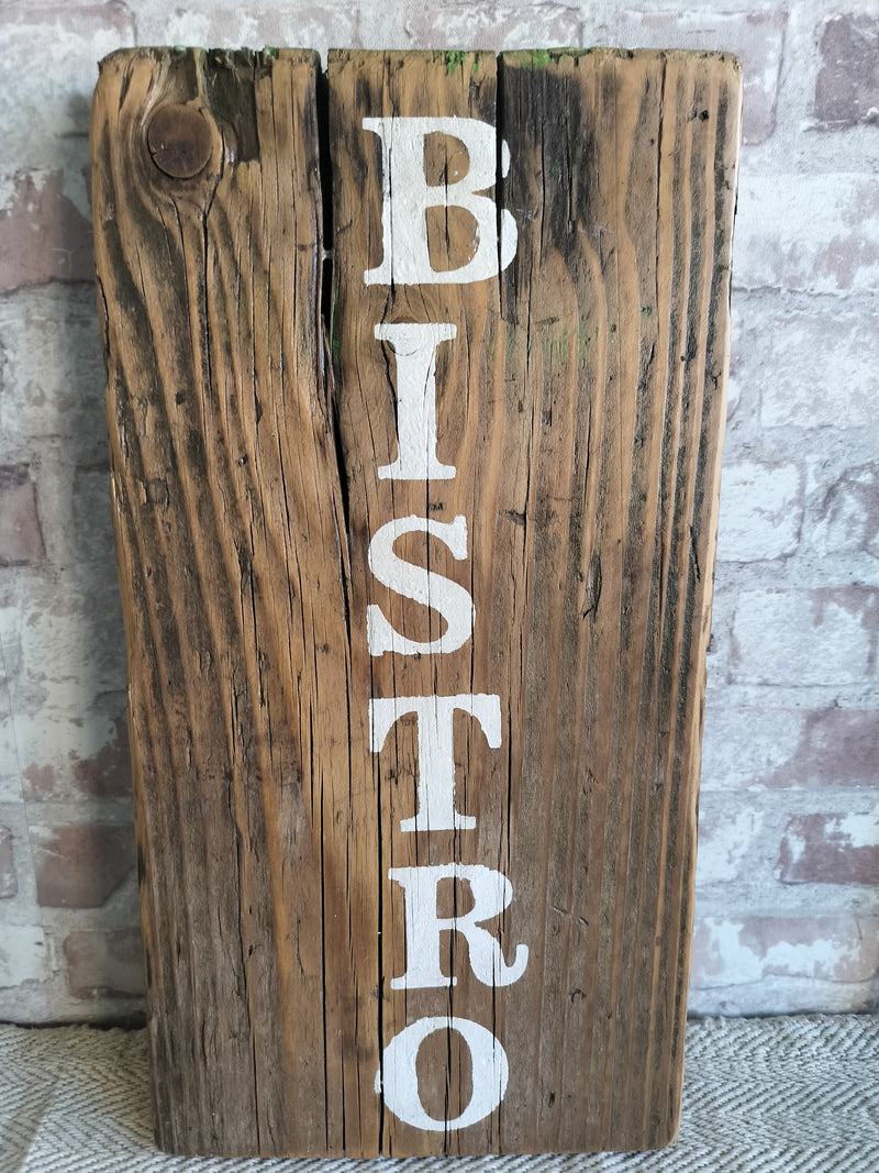Upcycled handmade wooden bistro sign with white lettering on rustic reclaimed wood background