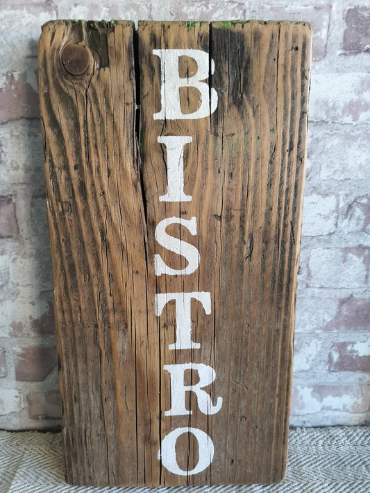 Upcycled handmade wooden bistro sign with white lettering on rustic reclaimed wood background