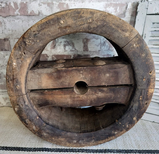Antique French wooden pulley wheel with rustic patina and iron bolts for vintage farmhouse decor
