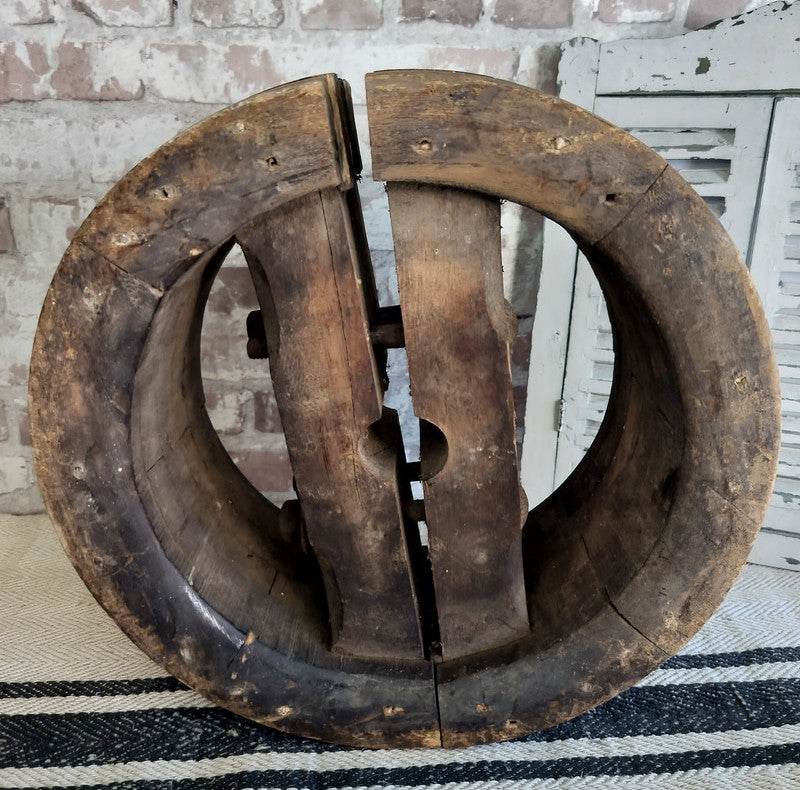 Antique French wooden pulley wheel with rustic farmhouse decor and aged patina