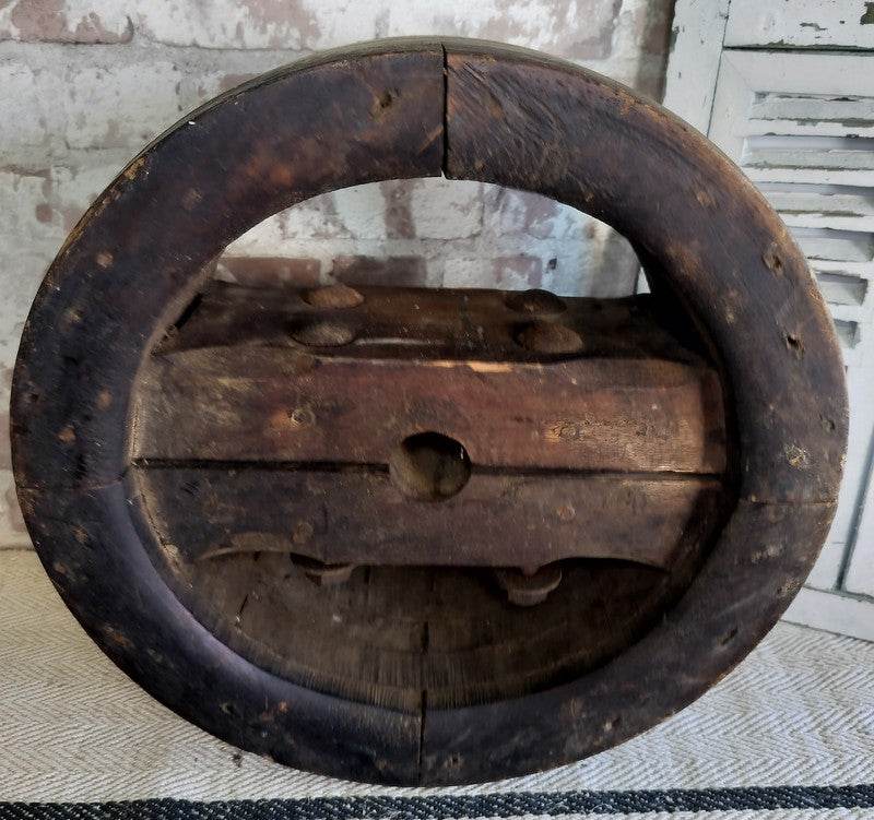 Antique French wooden pulley wheel with rustic patina and iron bolts, vintage farmhouse decor piece