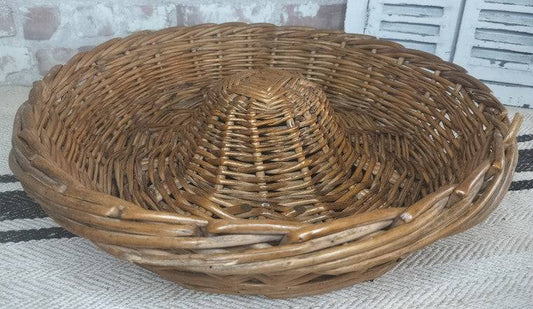 Vintage French Boulangerie bread proving basket made of handwoven wicker with cone-shaped center for rustic loaf rising.