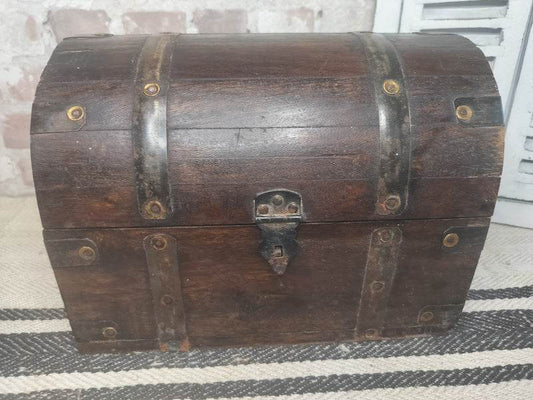 Vintage French wooden chest with dark stained wood, metal bands, rivets, and domed lid for keepsake storage.