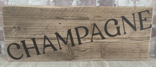 Upcycled handmade wooden champagne sign with black lettering on natural wood background, rustic decor for indoor and outdoor use