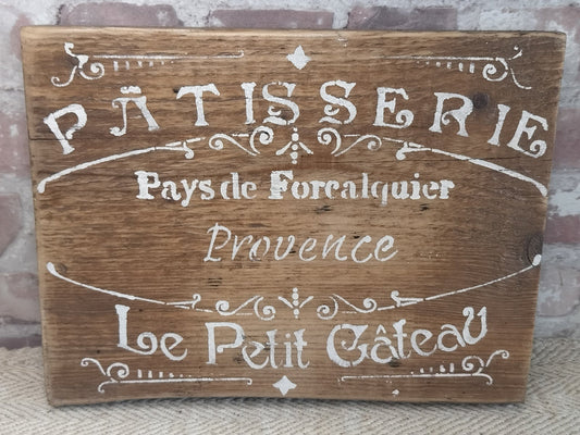 Upcycled handmade wooden patisserie sign with rustic white lettering on natural wood background