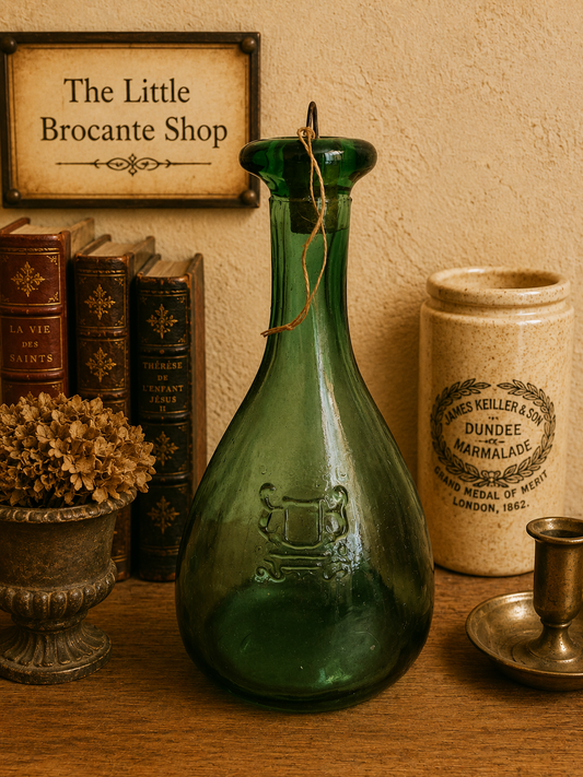 A wonderfully characterful vintage green glass carafe or bottle, with a beautiful deep emerald colour and an unusual elongated teardrop shape. photograph 1